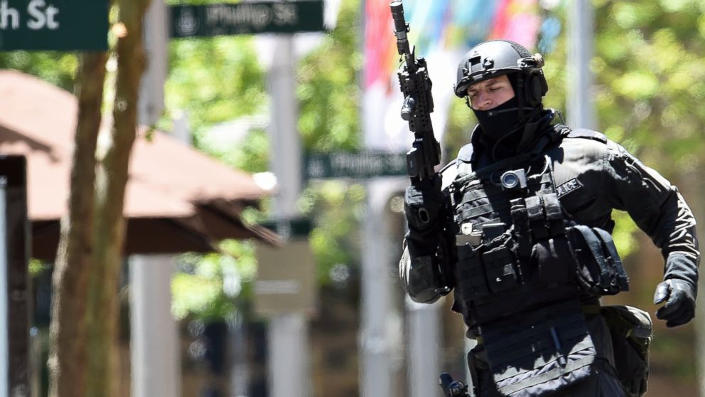 An armed policeman is seen outside a cafe in the central business district of Sydney on Dec. 15, 2014. 
