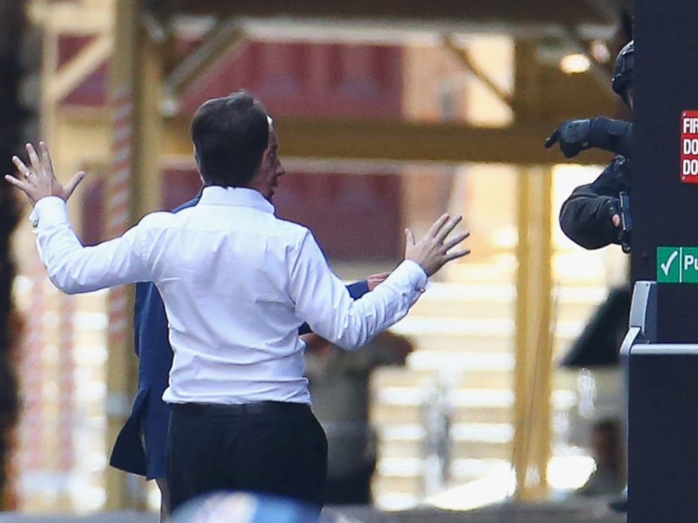 PHOTO: Two hostages run to safety outside the Lindt Cafe, Martin Place on December 15, 2014 in Sydney, Australia.