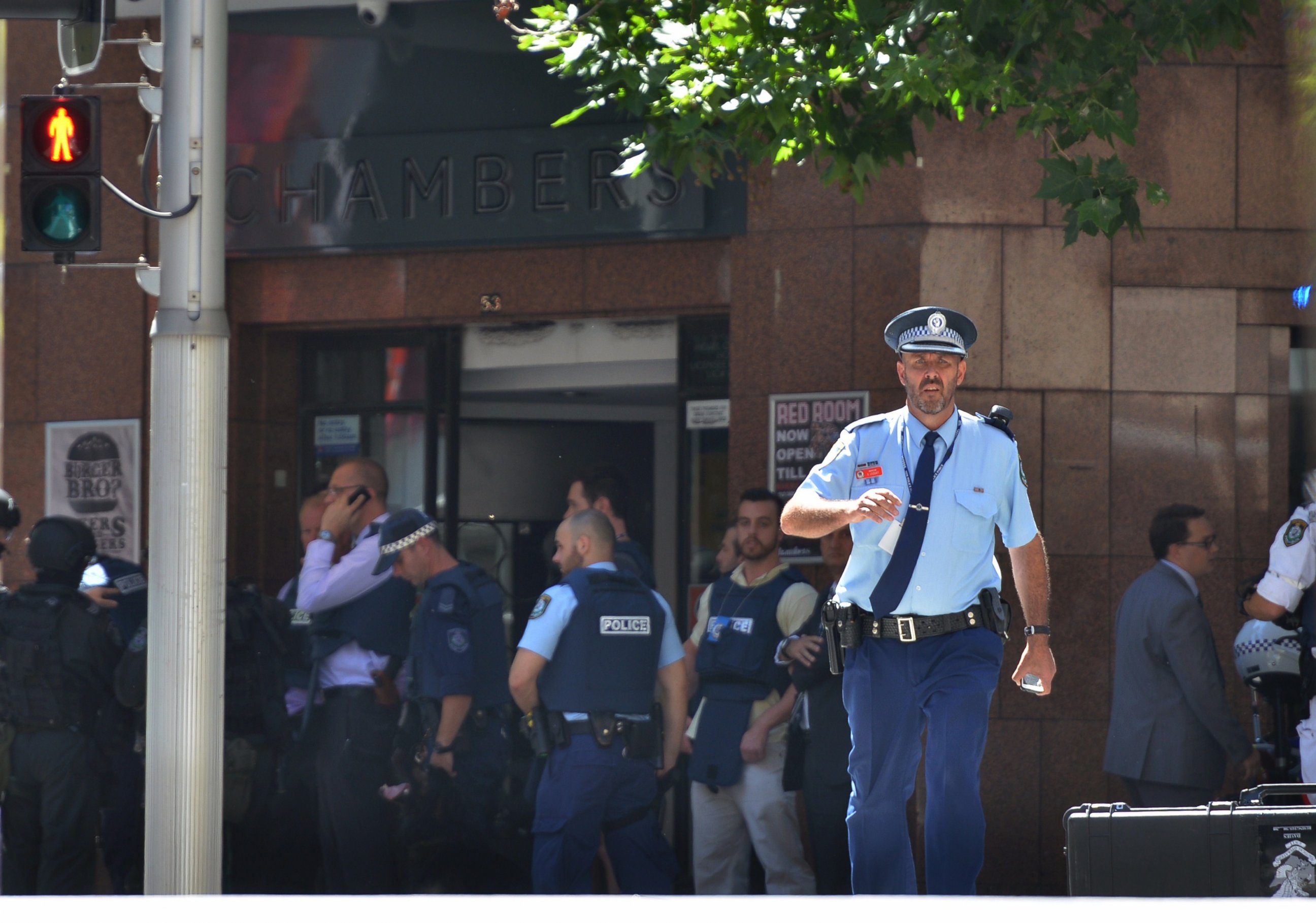 PHOTO: Armed police are seen outside a cafe in the central business district of Sydney on Dec. 15, 2014.  