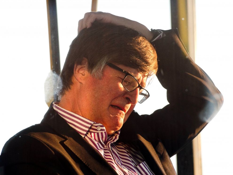 PHOTO: The family member of a passenger killed in the crash of Air Malaysia flight MH17 grieves as he waits on a bus to depart Schiphol airport in Amsterdam, Netherlands.