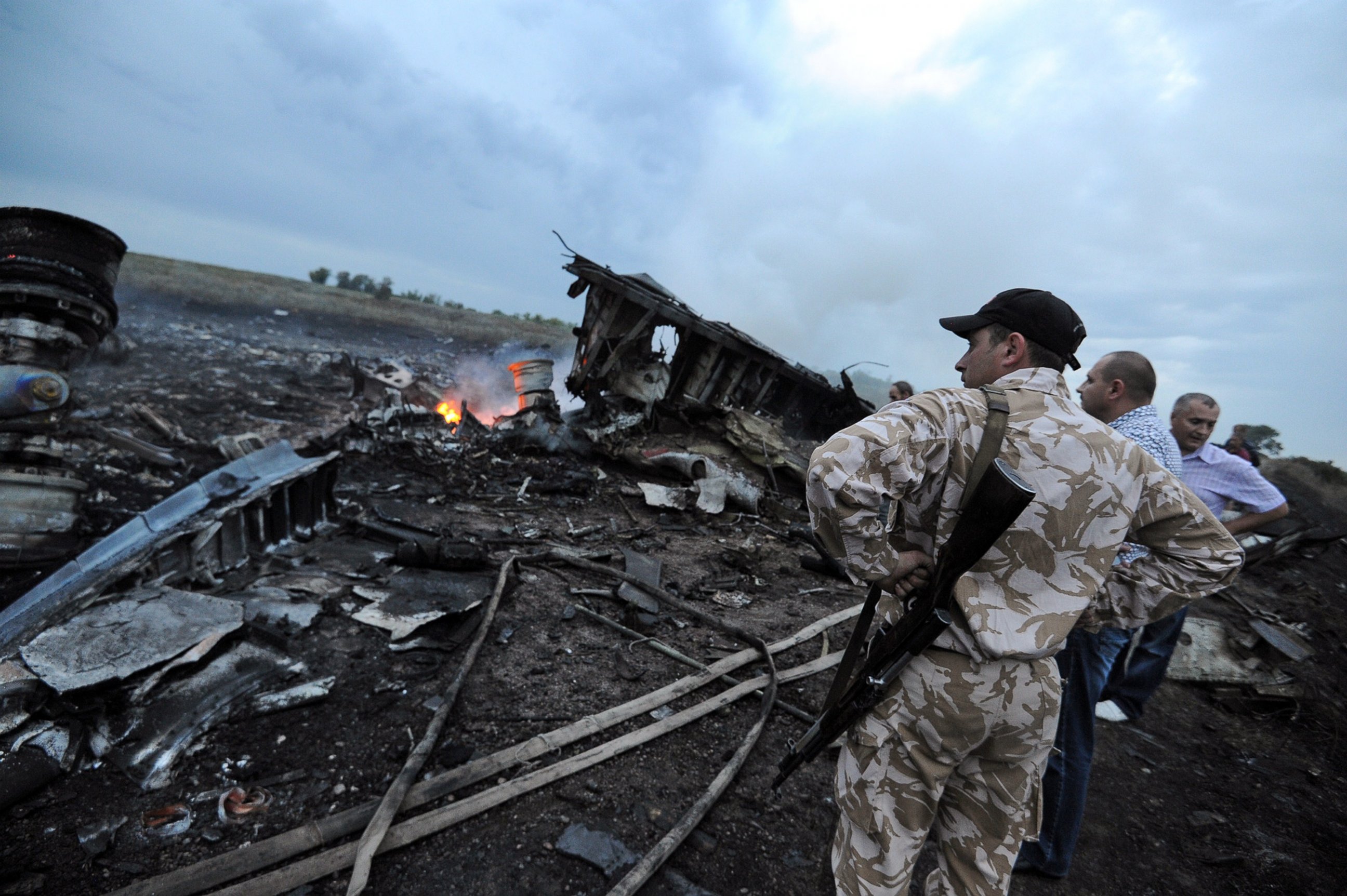PHOTO: Men stand next to the wreckage of the Malaysian airliner that crashed near the town of Shaktarsk in rebel-held east Ukraine on July 17, 2014.