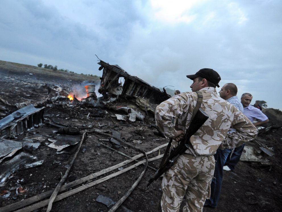 PHOTO: Men stand next to the wreckage of the Malaysian airliner that crashed near the town of Shaktarsk in rebel-held east Ukraine on July 17, 2014.