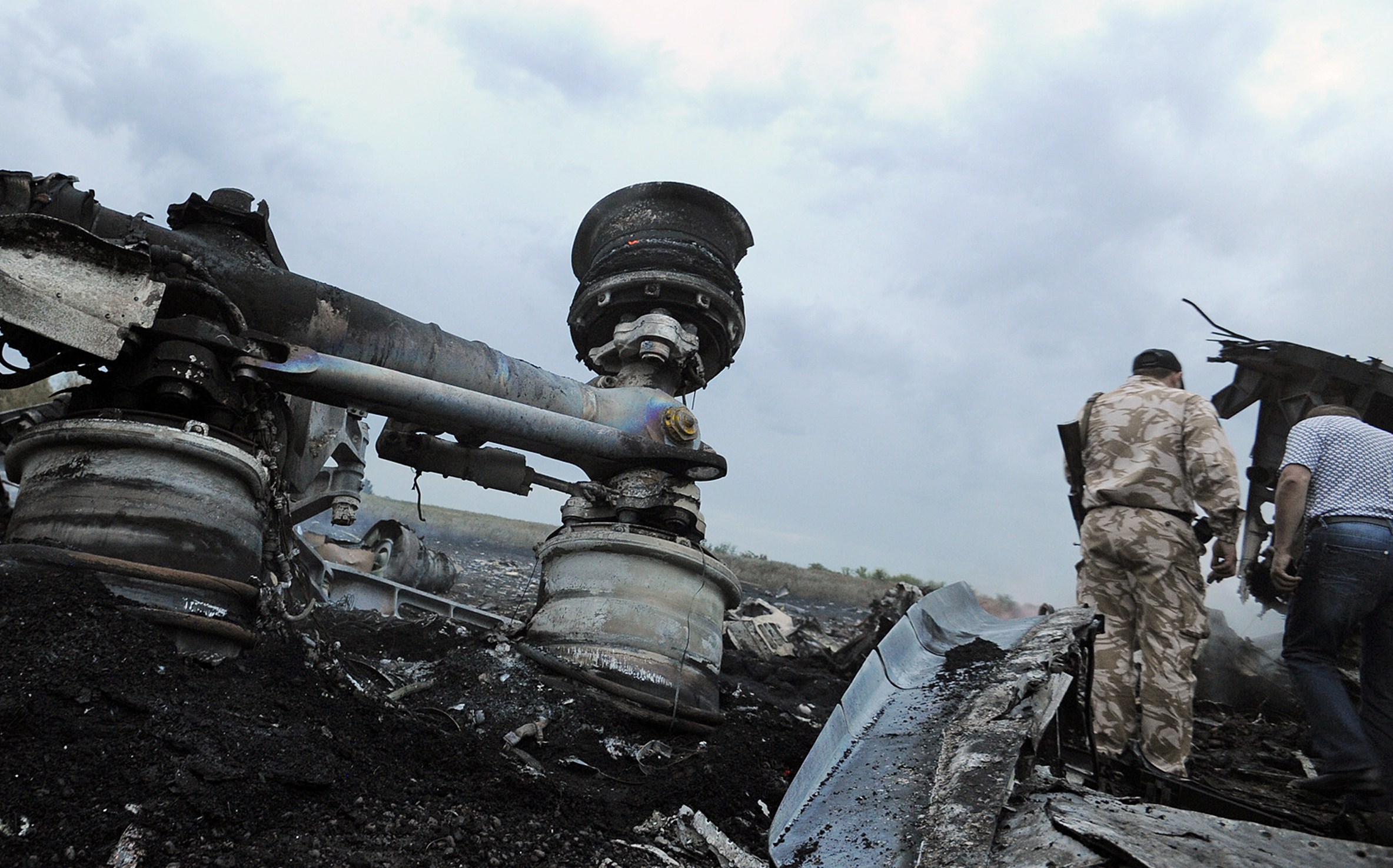 PHOTO: Men explore the wreckage of the Malaysian airliner that crashed in east Ukraine while traveling from Amsterdam to Kuala Lumpur on July 17, 2014.