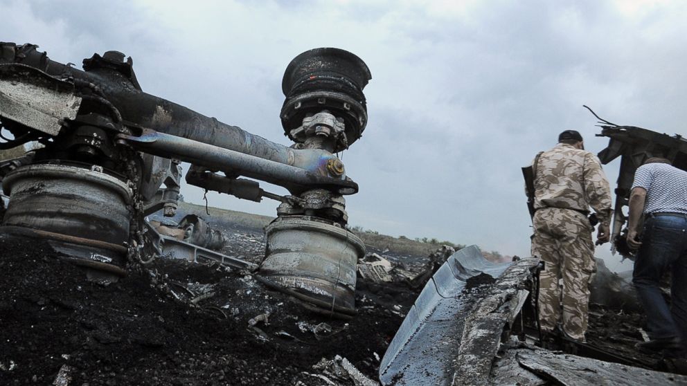 Men explore the wreckage of the Malaysian airliner that went down in east Ukraine while traveling from Amsterdam to Kuala Lumpur on July 17, 2014.