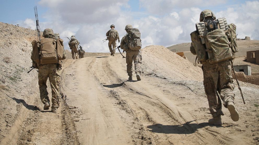 PHOTO: Soldiers with the U.S. Army's 2nd Battalion patrol on the edge of a village near Pul-e Alam, Afghanistan on March 29, 2014.