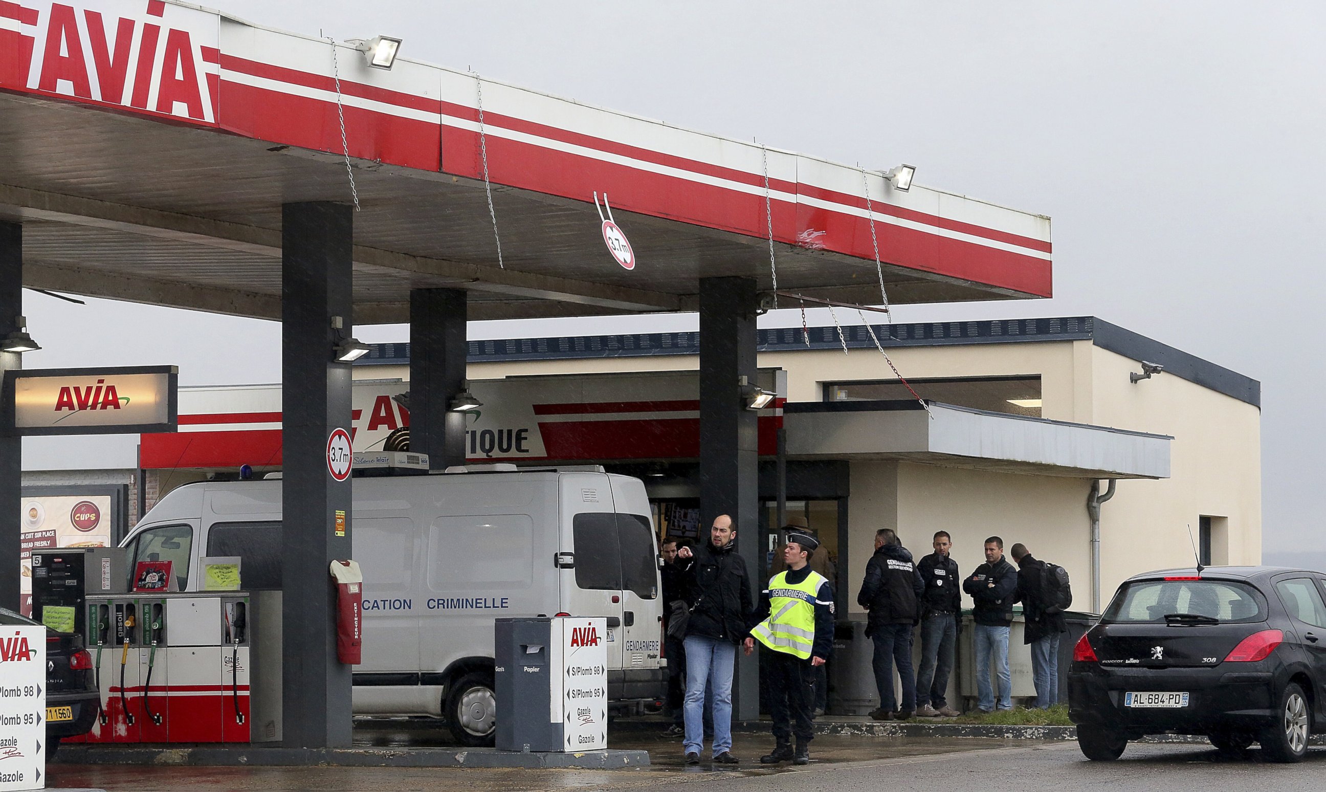 PHOTO: Gendarmes investigate where the two armed suspects from the attack on newspaper Charlie Hebdo were possibly spotted at an Avia gas station in Villers-Cotterets, north-east of Paris, Jan. 8, 2015. 