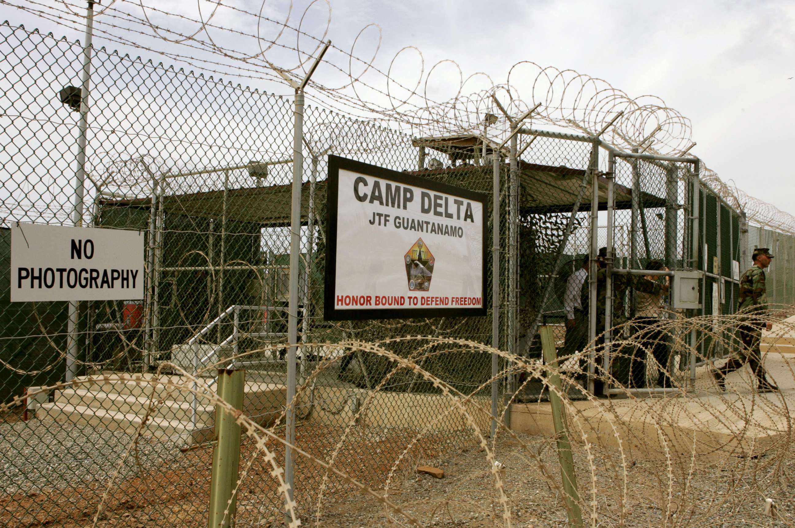 PHOTO: A Soldier walks through a gate at Camp Delta at Guantanamo Naval Base Aug. 23, 2004, in Guantanamo, Cuba.