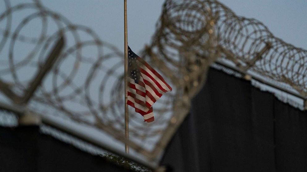 PHOTO: In this Aug. 29, 2021, file photo reviewed by U.S. military officials, a flag flies at half-staff in honor of the U.S. service members killed in the attack in Kabul, Afghanistan, as seen from Camp Justice in Guantanamo Bay Naval Base, Cuba.