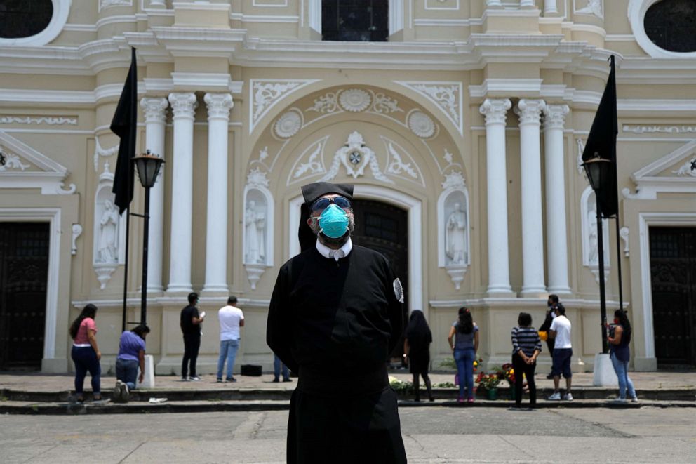 PHOTO: A member of the Brotherhood of El Calvario church, wearing a protective face mask, looks on outside the Santo Domingo church on Good Friday, as the spread of COVID-19 continues, in Guatemala City, Guatemala, April 10, 2020.