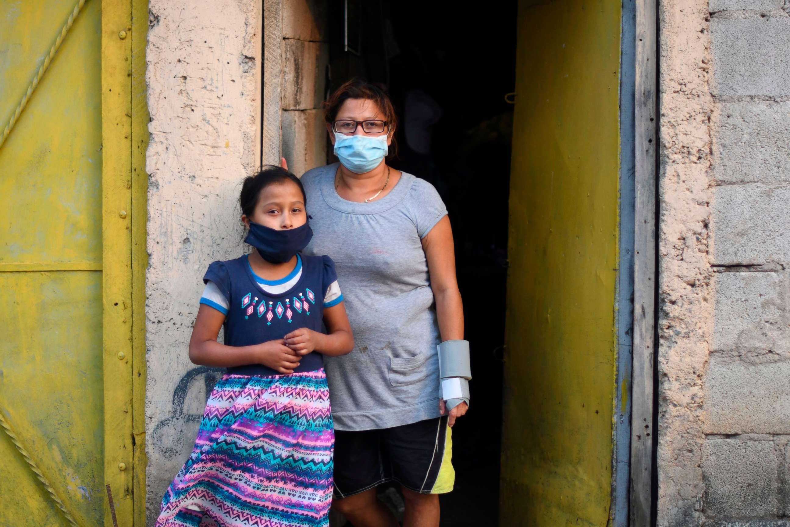 PHOTO: Locals wear face masks as a preventive measure against the spread of new coronavirus, COVID-19, during a partial curfew ordered by the government, at Las Brisas del Lago neighborhood, in Villa Nueva. south Guatemala City on April 14, 2020.