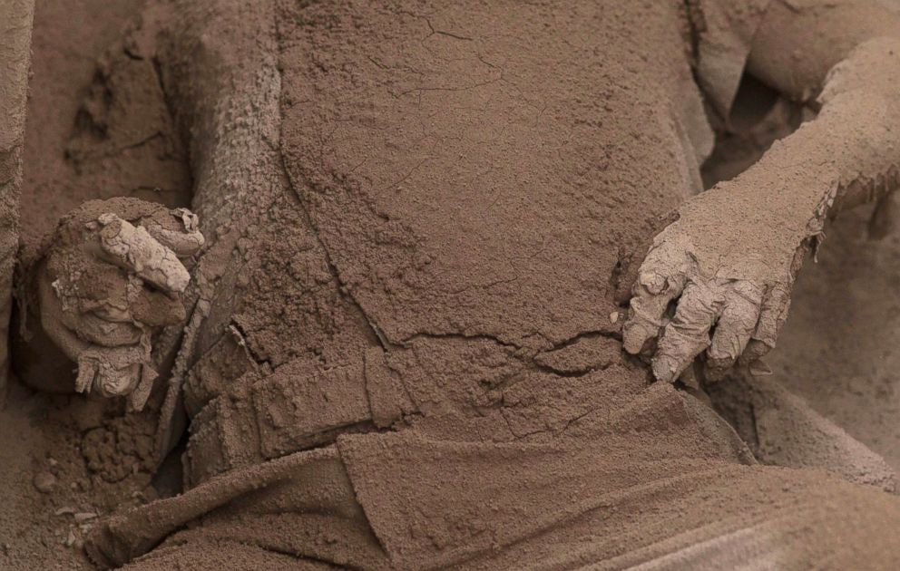 PHOTO: The body of a victim is covered in volcanic ash spewed by the Volcan de Fuego, or "Volcano of Fire," in Escuintla, Guatemala, June 4, 2018.