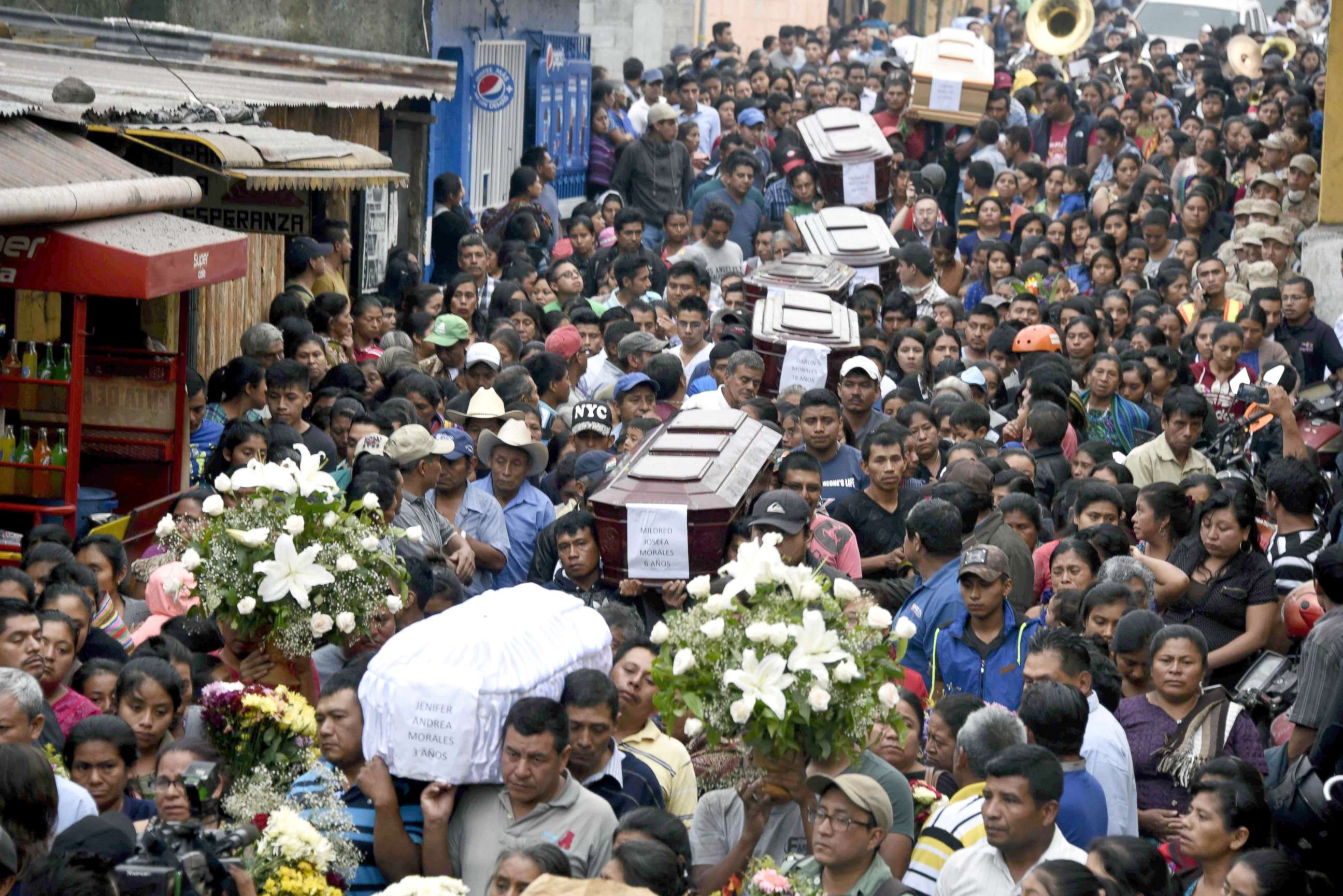 PHOTO: Residents carry the coffins of seven people who died following the eruption of the Fuego volcano, along the streets of Alotenango municipality, Sacatepequez, about 40 miles southwest of Guatemala City, June 4, 2018.