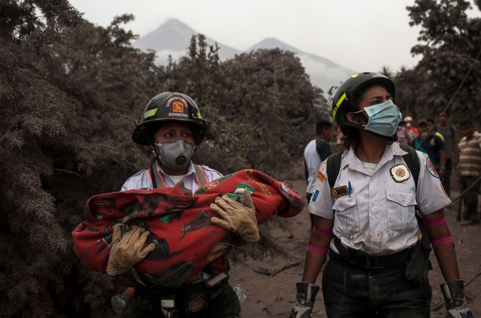 PHOTO: A firefighter carries the body of a child recovered near the Volcan de Fuego, or "Volcano of Fire," in Escuintla, Guatemala, June 4, 2018.