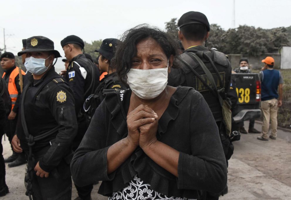 PHOTO: A woman cries for her missing relatives during the search for victims in San Miguel Los Lotes, in Escuintla, Guatemala on June 4, 2018, a day after the eruption of the Fuego volcano.