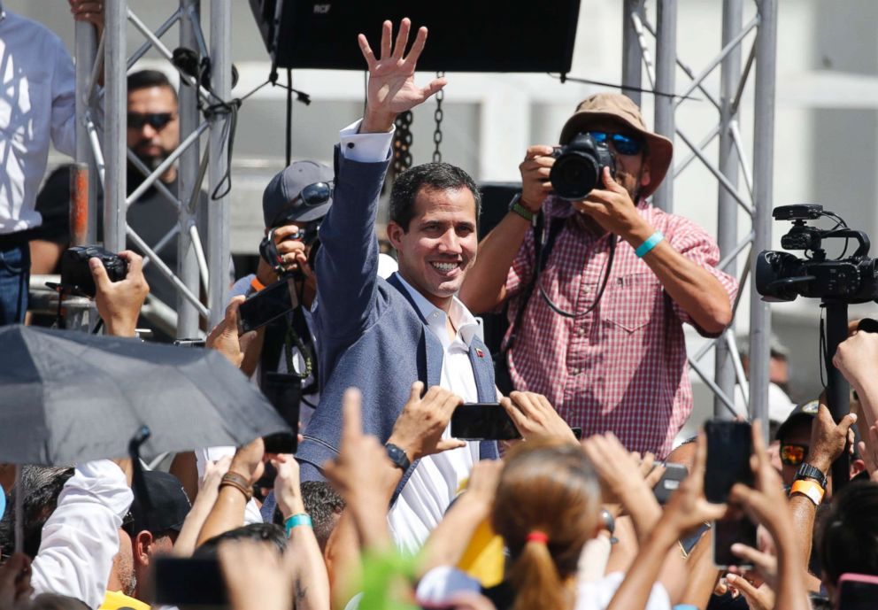 PHOTO: Venezuela's self-proclaimed interim president Juan Guiado greets the crowd during an event to swear in nurses, doctors, that will help with the arrival and distribution of humanitarian aid in in Caracas, Venezuela, Feb. 16, 2019. 