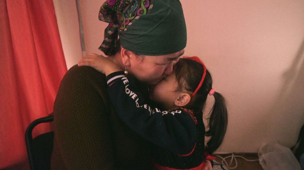 PHOTO: Bayan tries to comfort her mother, Gulzira Auelkhan, as she weeps while recalling being tortured while in Chinese custody, in 2019 while they were living in Kazakhstan.