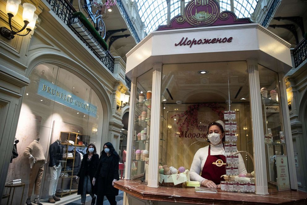 PHOTO: An ice cream seller wearing a face mask to protect against the novel coronavirus waits for customers as GUM (the Russian acronym for State Department Store) welcomes its first visitors after reopening in Moscow, Russia, on June 1, 2020.