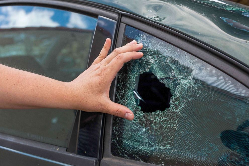 PHOTO: A resident's hand shows the damage to a window of vehicle in the village of Saint-Sornin, July 5, 2018, after violent hailstorms ripped through the area some 50 miles north-west of Bordeaux in western France late July 4.