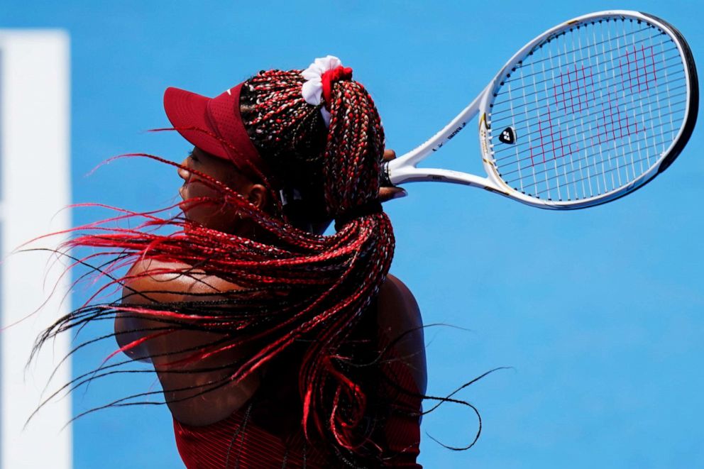 PHOTO: Naomi Osaka, of Japan, serves to Viktorija Golubic, of Switzerland, during second round of the tennis competition at the 2020 Summer Olympics, July 26, 2021, in Tokyo, Japan.
