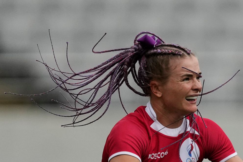 PHOTO: Russian Olympic Committee's Alena Tiron's braids fly as she plays in their women's rugby sevens match against New Zealand at the 2020 Summer Olympics, July 30, 2021 in Tokyo, Japan.