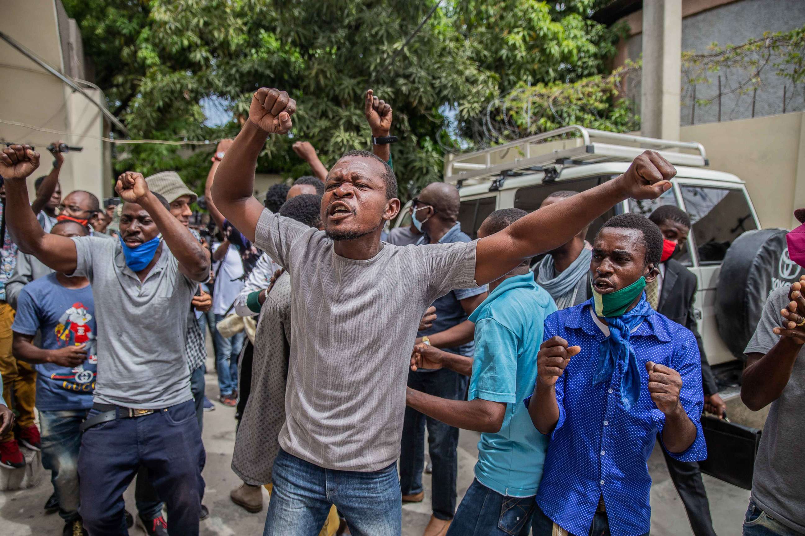 PHOTO: Supporters of former Senate President Youri Latortue shout outside a courthouse where Latortue and former senator Steven Benoit are being questioned on July 12, 2021 in Port-au-Prince, Haiti.