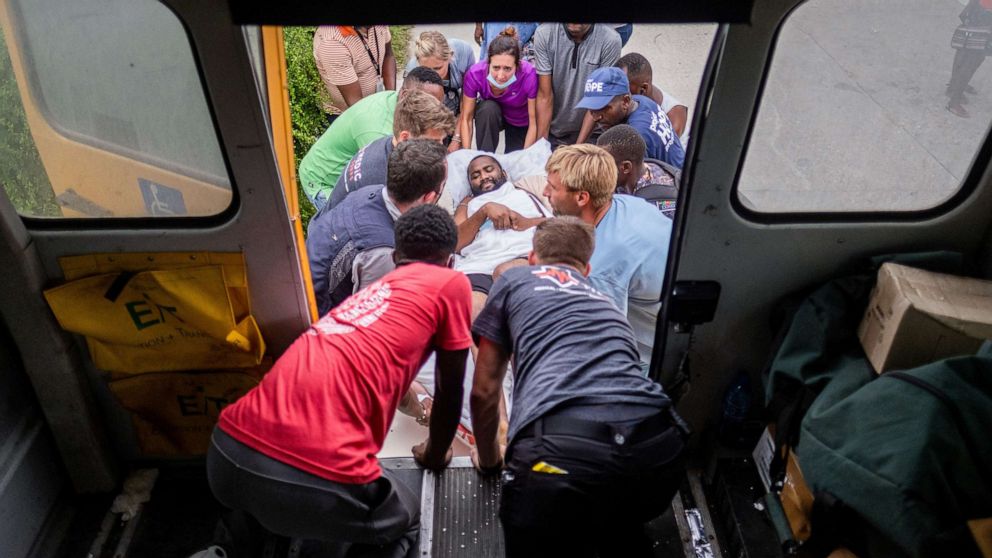 PHOTO: An injured patient is loaded by volunteer medics to a school bus to be transported to a hospital, after a 7.2 magnitude earthquake in Les Cayes, Haiti, Aug. 19, 2021.