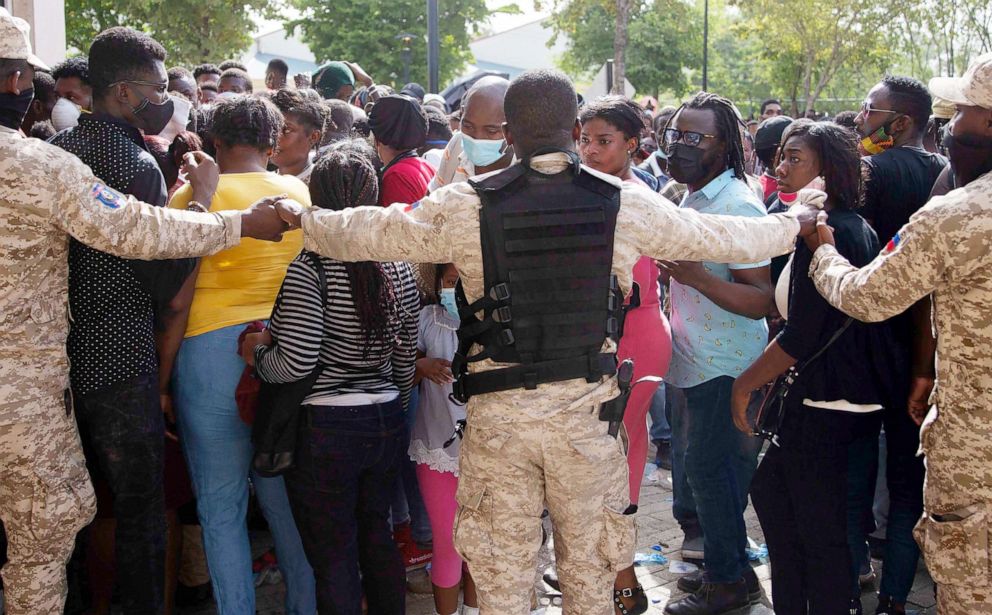 PHOTO: Haitian Police holds hands forming a cordon in front of the U.S. Embassy in Port-au-Prince, Haiti,, July 9, 2021.