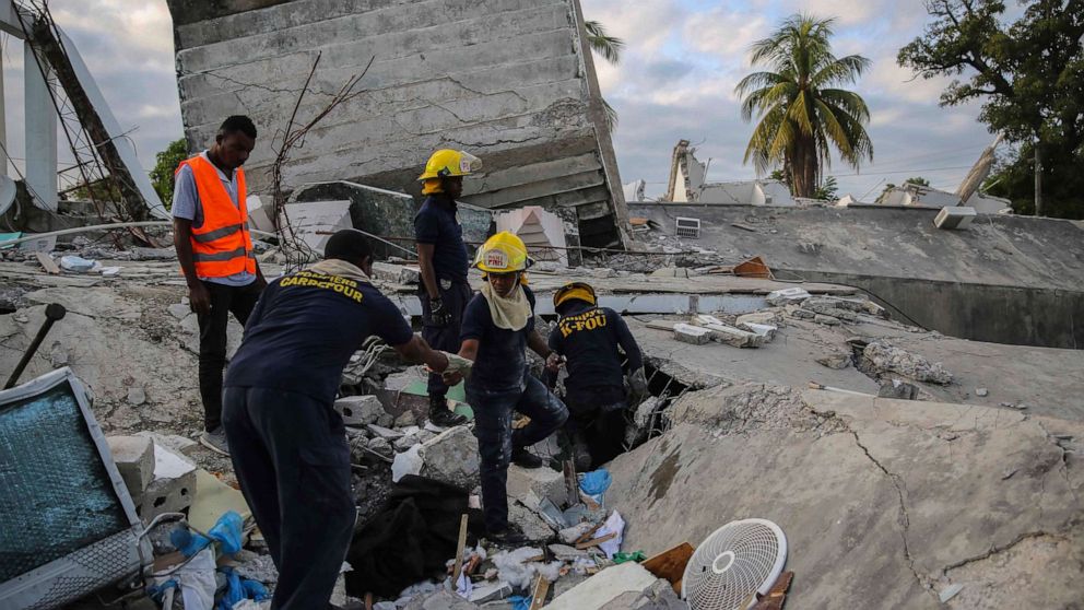 PHOTO: Firefighters search for survivors inside a collapsed building after a 7.2 magnitude earthquake in Les Cayes, Haiti, Aug. 15, 2021.