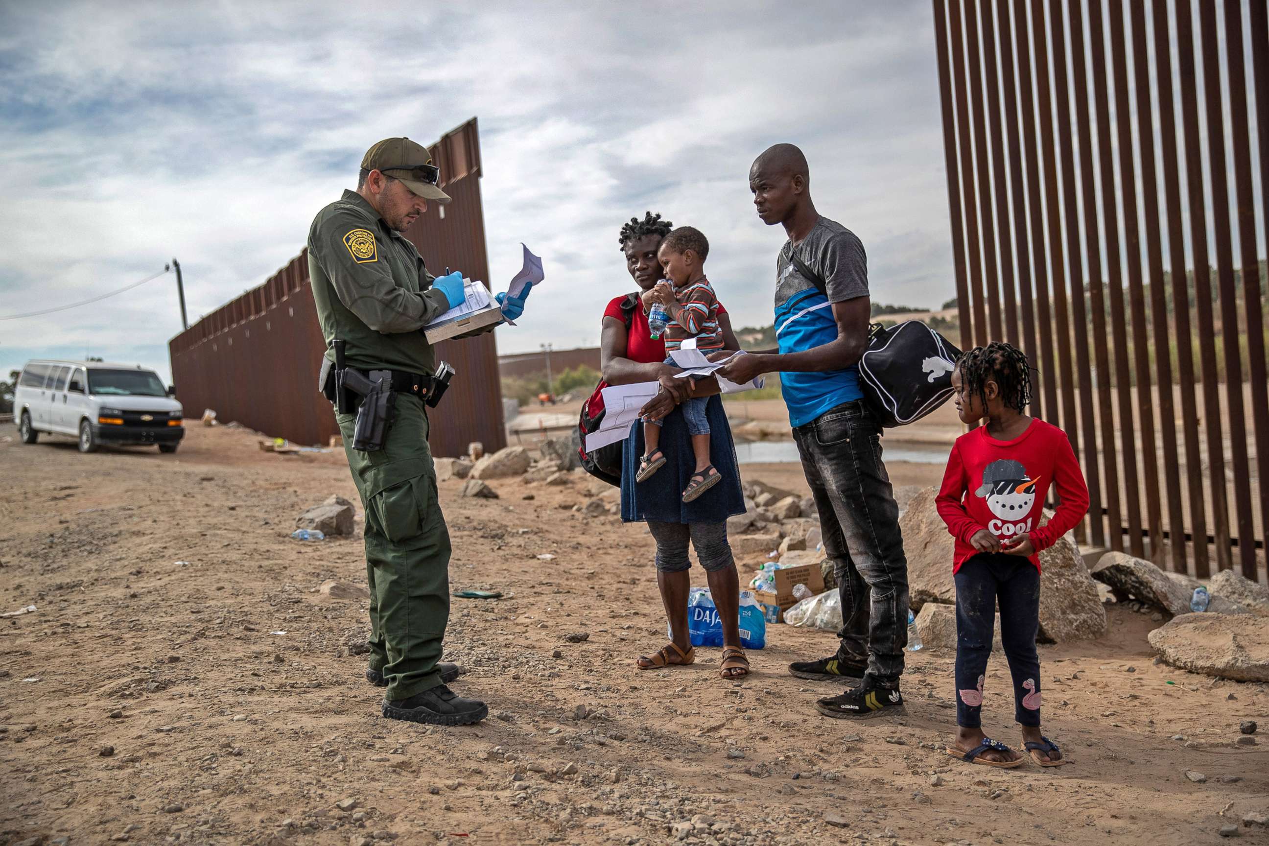 PHOTO: An immigrant family from Haiti is taken into custody by a U.S. Border Patrol agent at the U.S.-Mexico border on Dec. 7, 2021 in Yuma, Ariz. Many families apply for asylum upon arrival to the U.S.