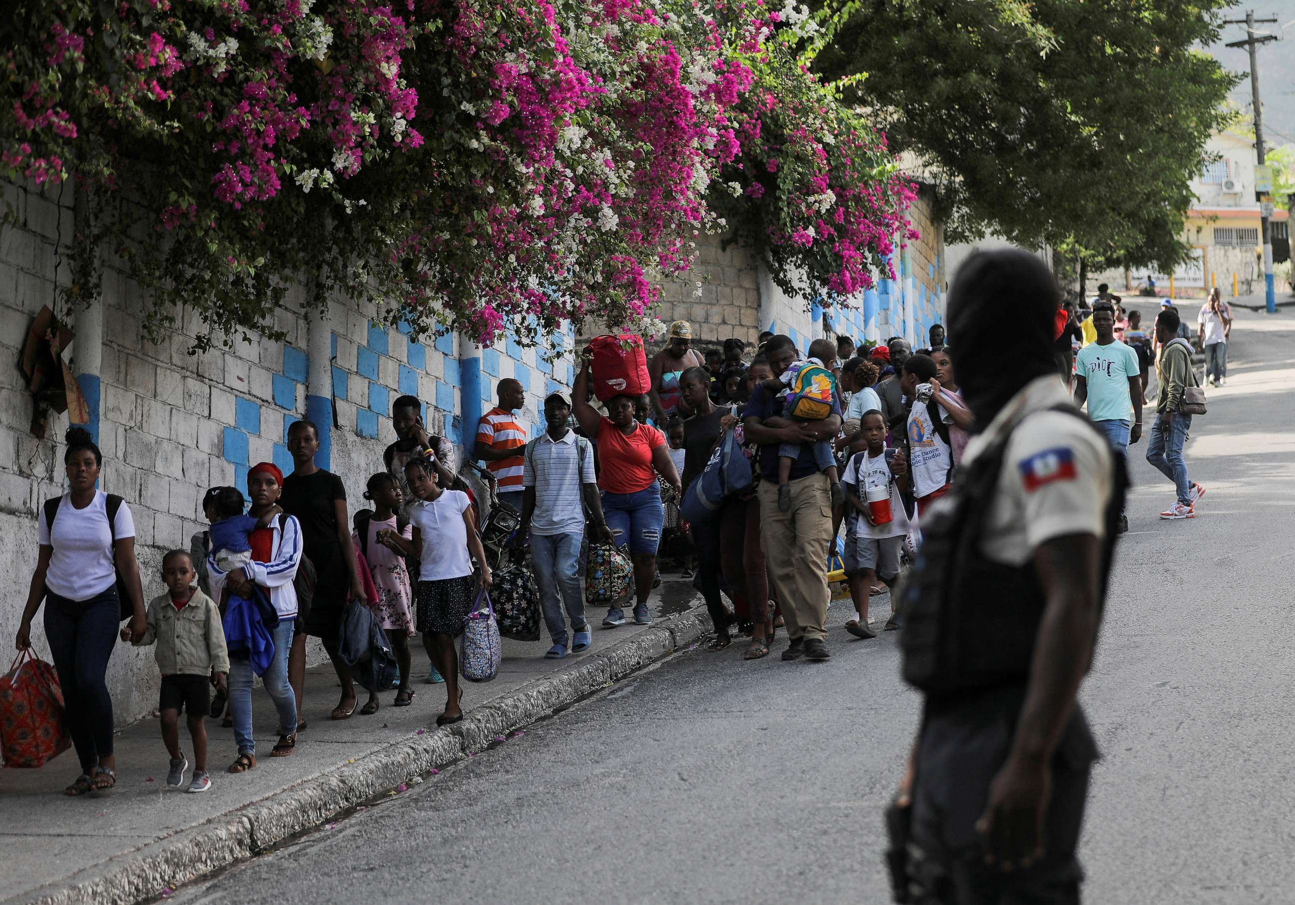 PHOTO: People carry their belongings while fleeing their homes and neighbourhood due to clashes between gangs, in Port-au-Prince, Haiti April 24, 2023. REUTERS/Ralph Tedy Erol/File Photo