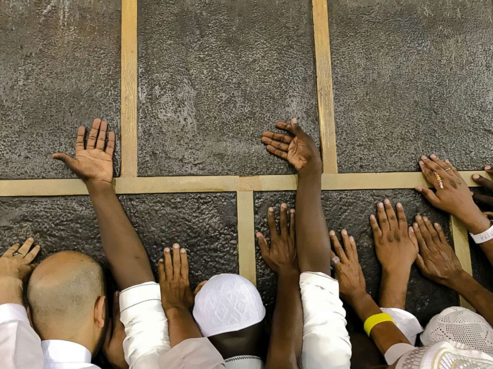 PHOTO: Muslim pilgrims touch the Kaaba stone, the cubic building at the Grand Mosque, as they pray ahead of the annual Hajj pilgrimage in the Muslim holy city of Mecca, Saudi Arabia, Aug. 17, 2018.