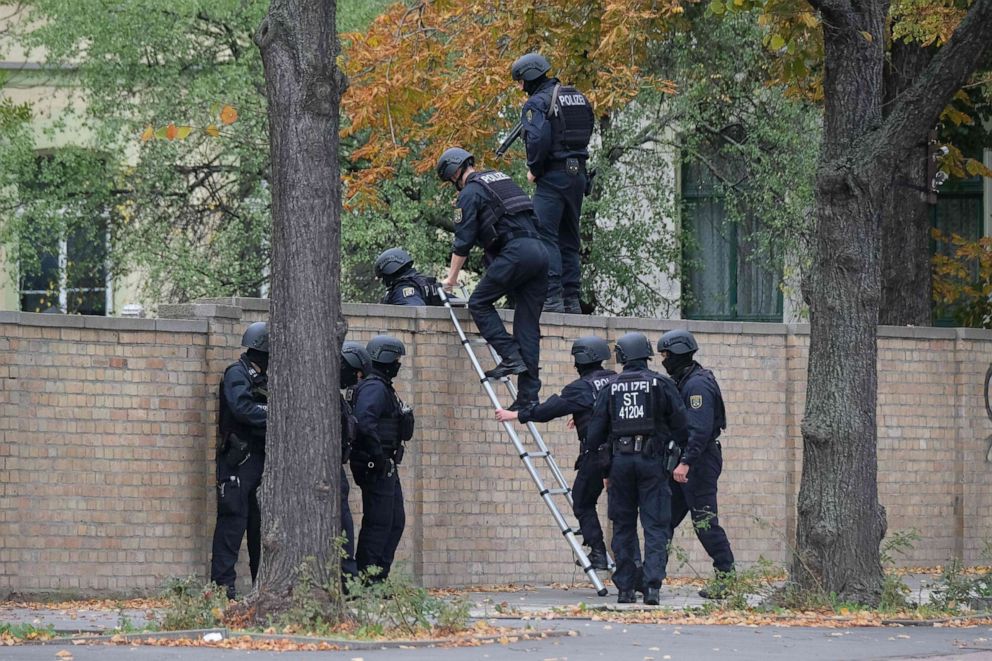 PHOTO: Policemen climb over a wall close to the site of a shooting in Halle an der Saale, eastern Germany, on Oct. 9, 2019.