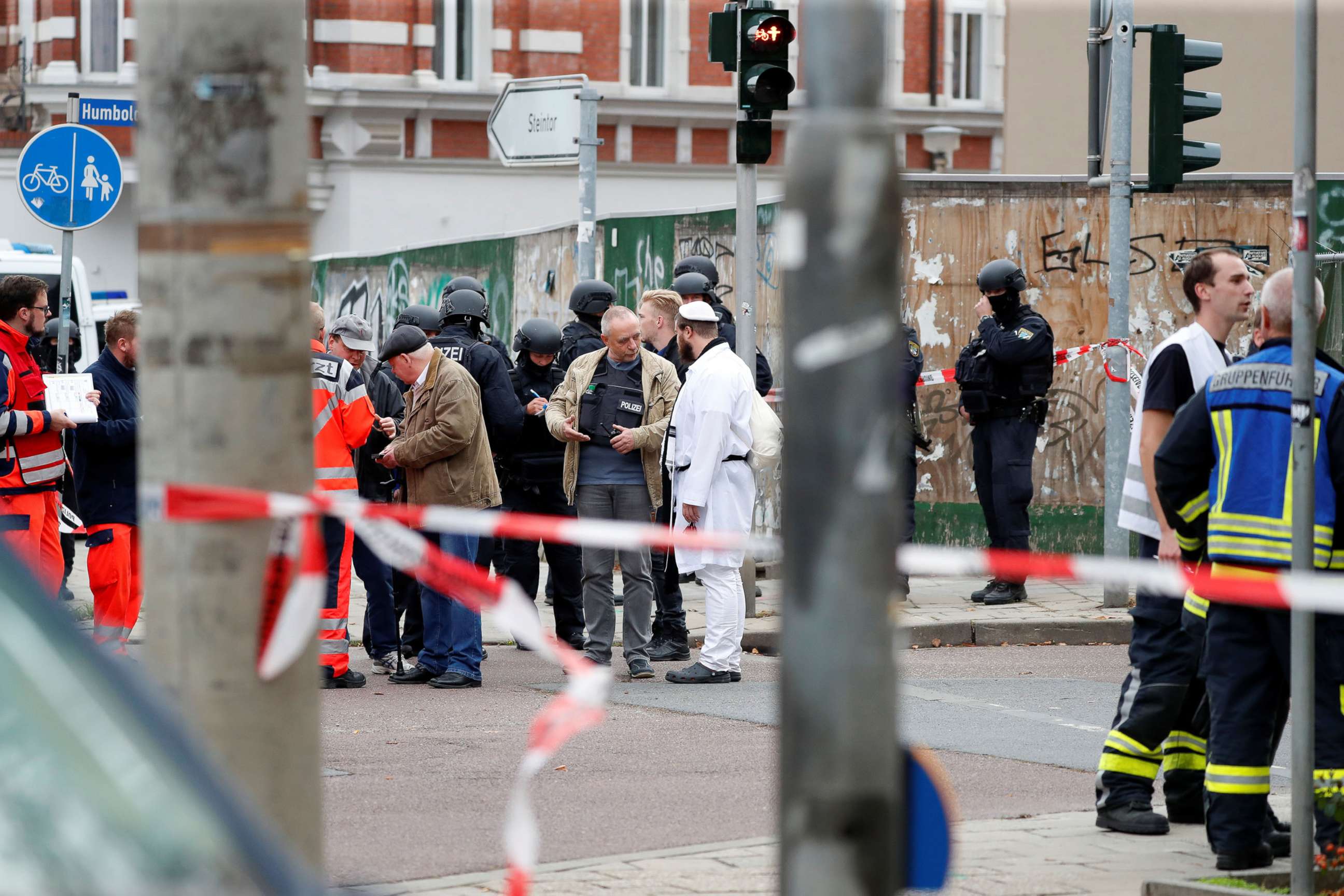 PHOTO: A police officer speaks with a Jewish man near the site of a shooting, in which two people were killed, in Halle, Germany, Oct. 9, 2019.