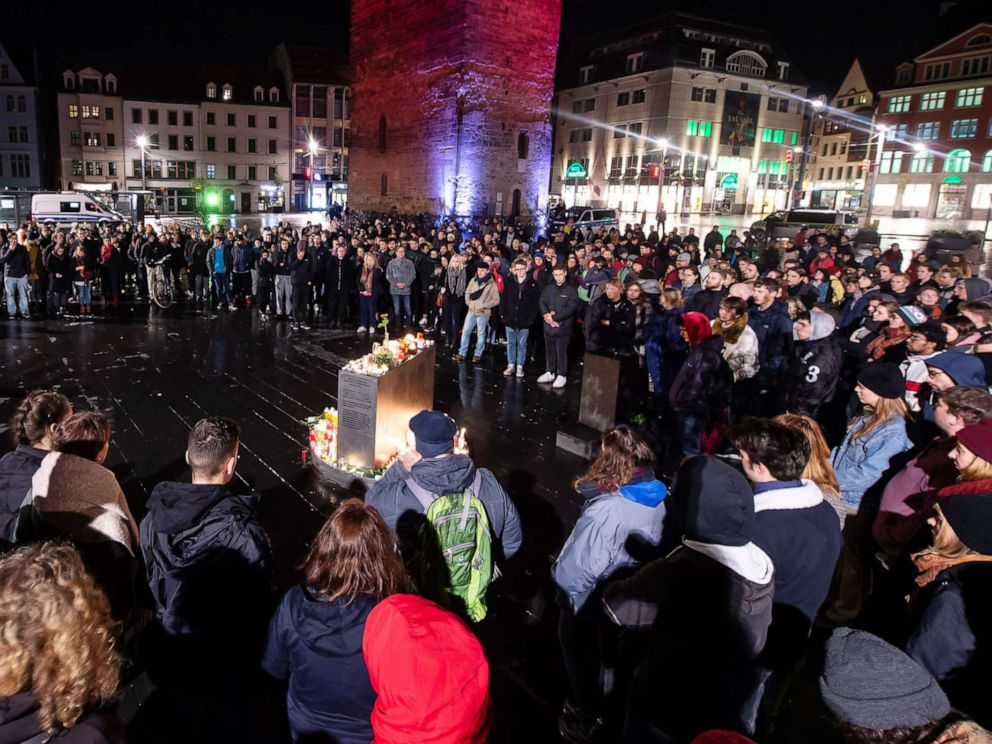 PHOTO: Mourners stand in front of the Red Tower on the market square in Halle, Germany, Oct. 9. 2019.