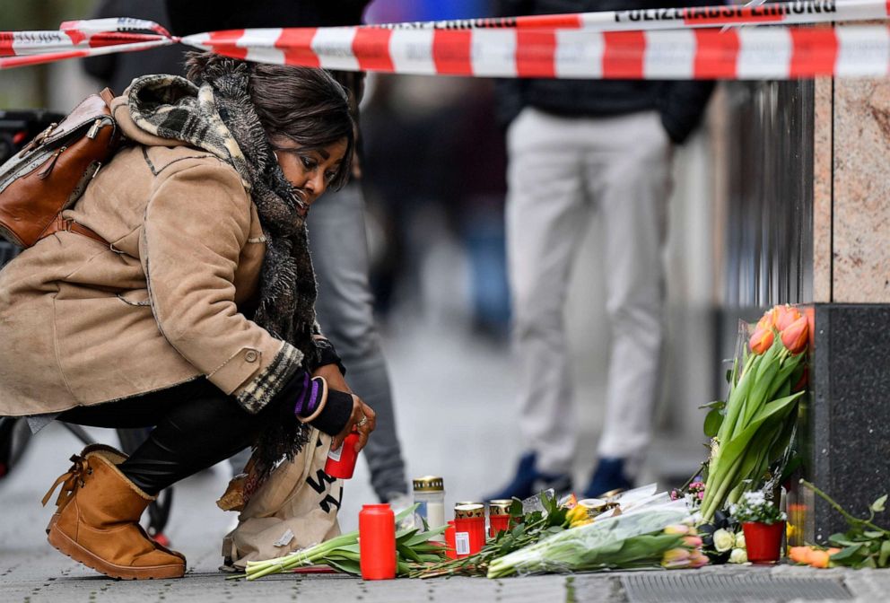 PHOTO: A woman sets a candle near the scene where several people were killed in Hanau, Germany, Feb. 20, 2020.