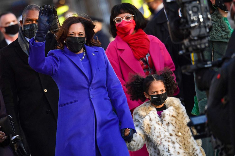 PHOTO: Vice President Kamala Harris holds the hand of her grand niece as they walk up Pennsylvania Avenue to enter the White House in Washington after Joe Biden and Kamala Harris were sworn in at the US Capitol on Jan. 20, 2021.