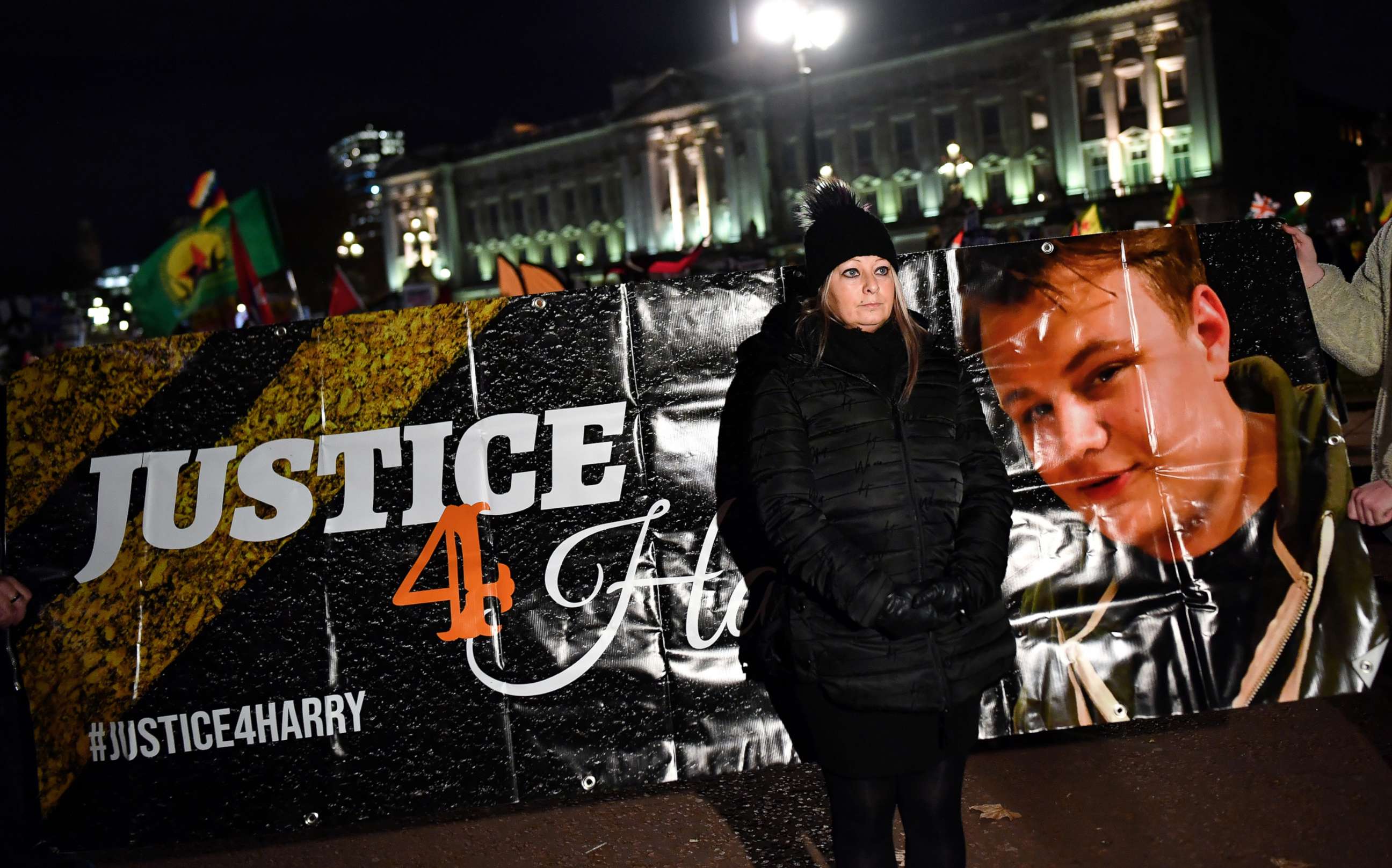 PHOTO: Harry Dunn's mother Charlotte Charles stands in front of a banner outside the Buckingham Palace at a demonstration during President Donald Trump's visit for the NATO summit, in London, Dec. 3, 2019.