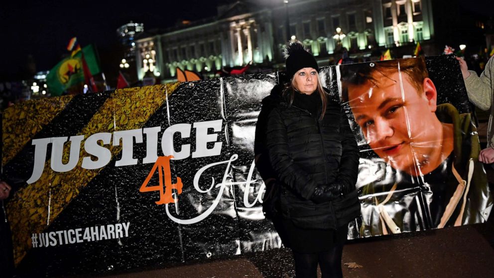 PHOTO: Harry Dunn's mother Charlotte Charles stands in front of a banner outside the Buckingham Palace at a demonstration during President Donald Trump's visit for the NATO summit, in London, Dec. 3, 2019.