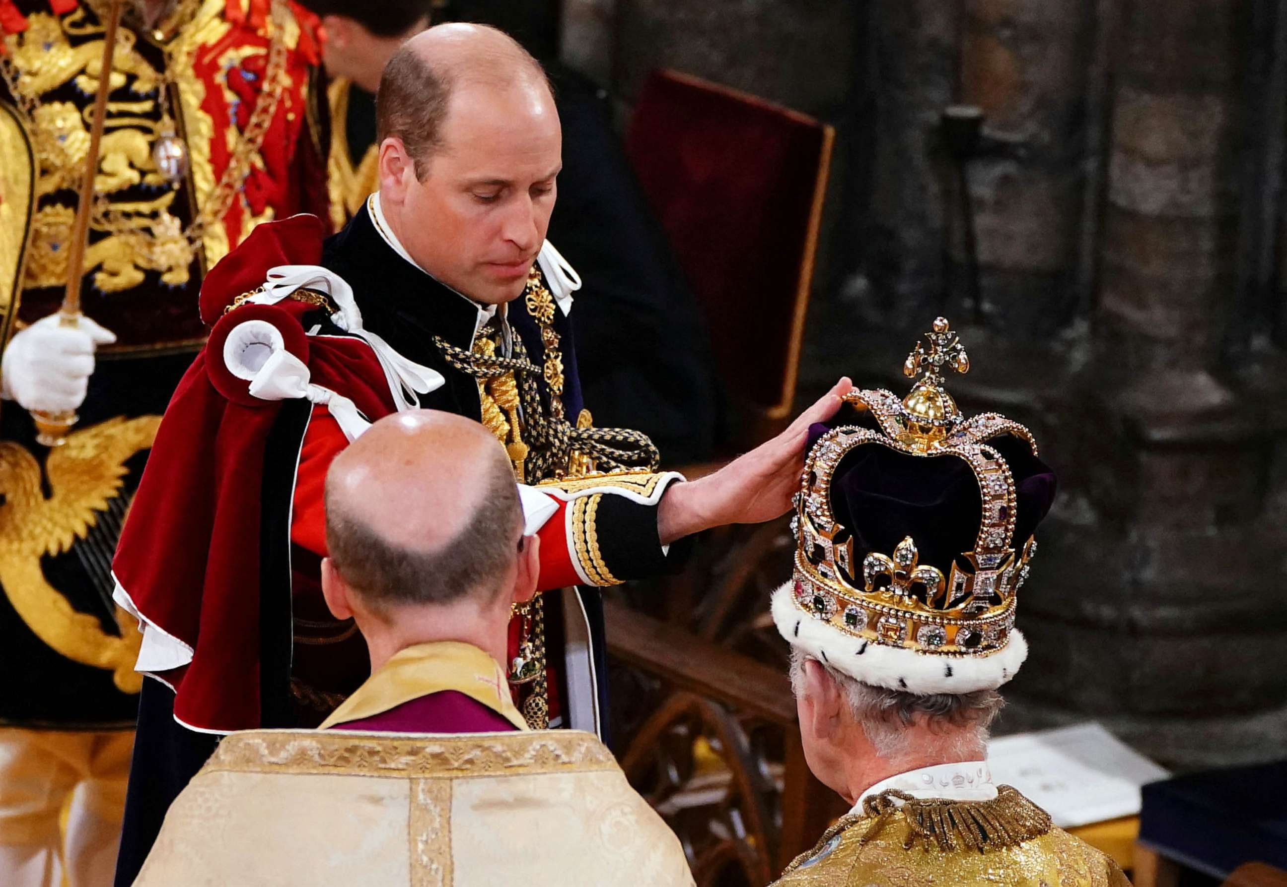 PHOTO: The Prince of Wales touches St Edward's Crown on King Charles III's head during his coronation ceremony in Westminster Abbey, London, May 6, 2023.
