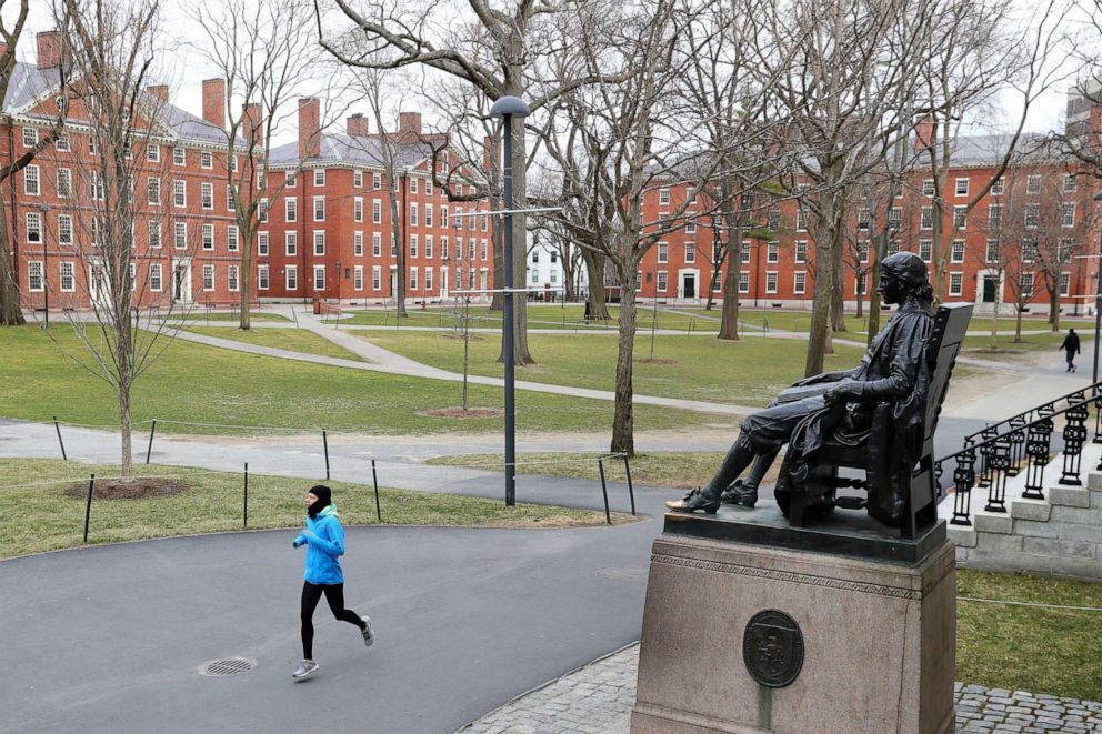 PHOTO: A runner crosses Harvard Yard on March 23, 2020 in Cambridge, Mass.