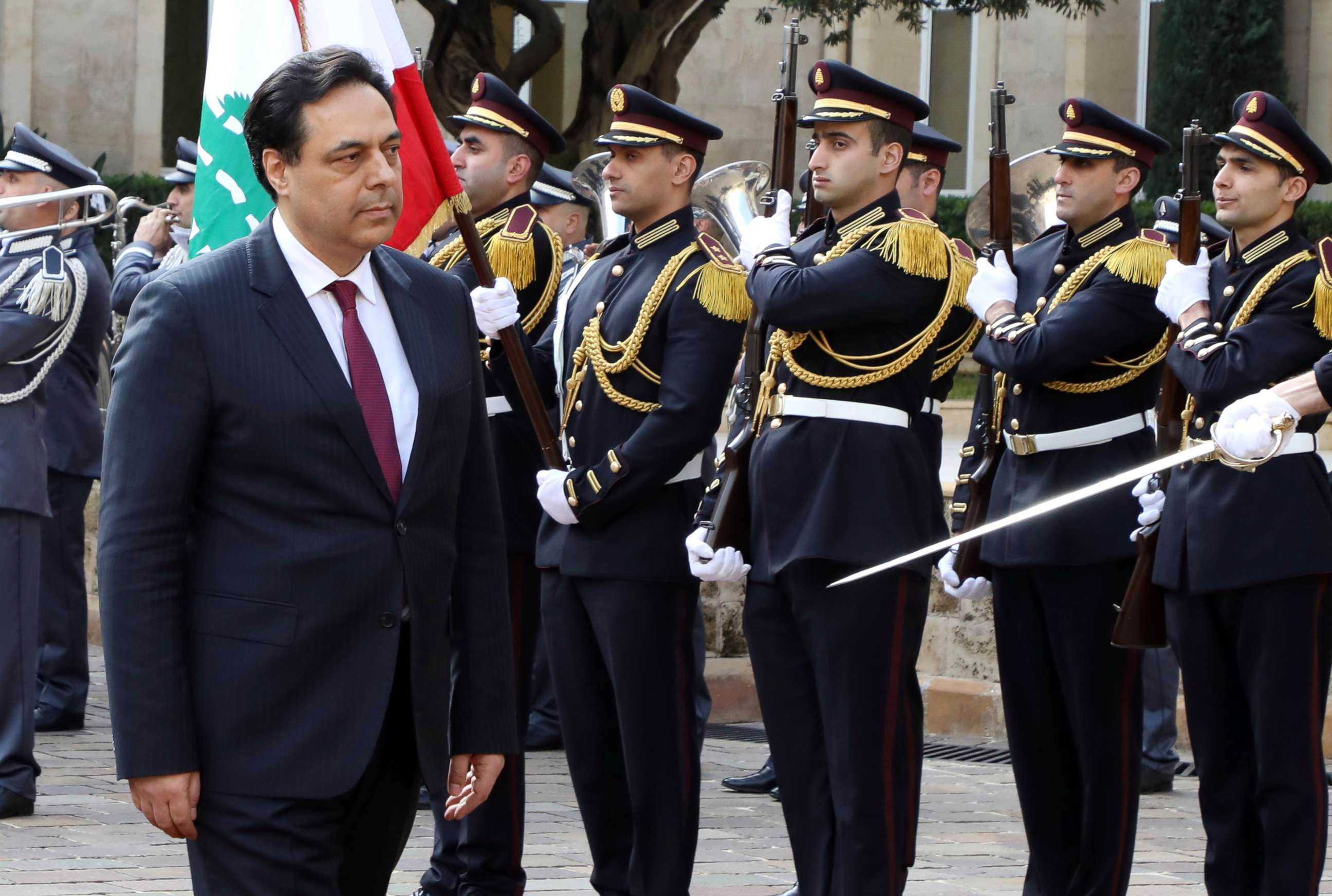 PHOTO: This photo released by the Lebanese Government shows Prime Minister Hassan Diab reviewing an honor guard during a ceremony on his first day at Government House in Beirut, Jan. 22, 2020. 