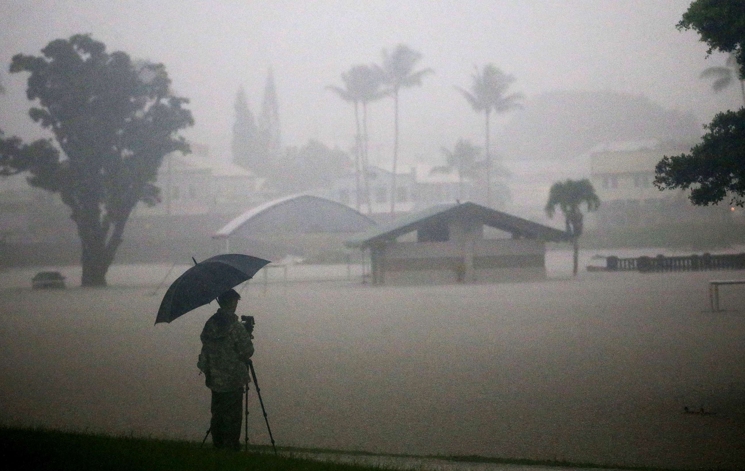 PHOTO: A man takes photos of floodwaters from Hurricane Lane rainfall on the Big Island, Aug. 23, 2018, in Hilo, Hawaii. Hurricane Lane has brought more than a foot of rain to some parts of the Big Island which is under a flash flood warning. 