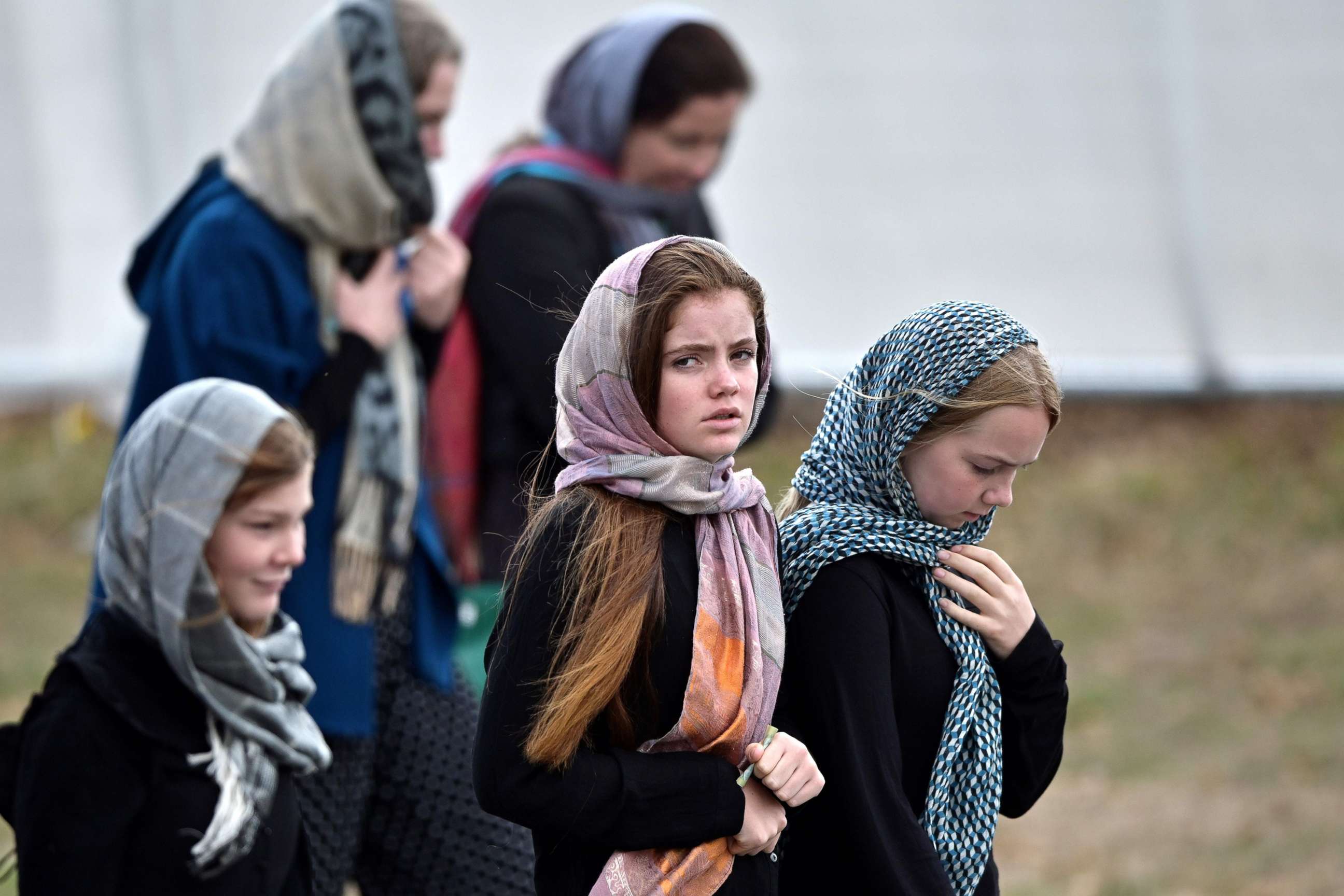 PHOTO: Residents and schoolchildren wearing headscarves arrive for the funeral of those killed in New Zealand's twin mosque attacks at Memorial Park cemetery in Christchurch,  March 21, 2019.