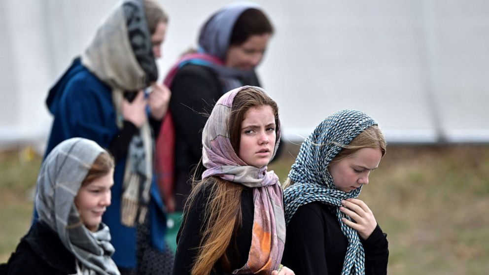 Girls adjust their headscarves before an Islamic prayer service for News  Photo - Getty Images