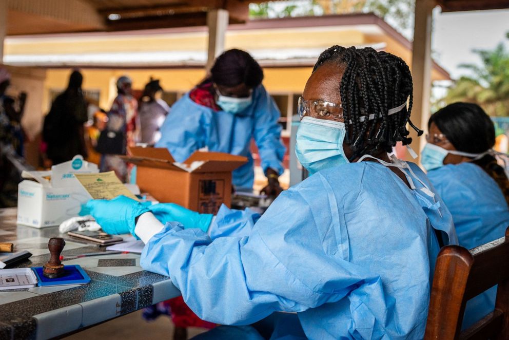 FILE PHOTO: A health worker prepares a vaccination certificate after vaccinating someone with a dose of a COVID-19 vaccine in Bimbo, near Bangui, Central African Republic, on Nov. 15, 2021.