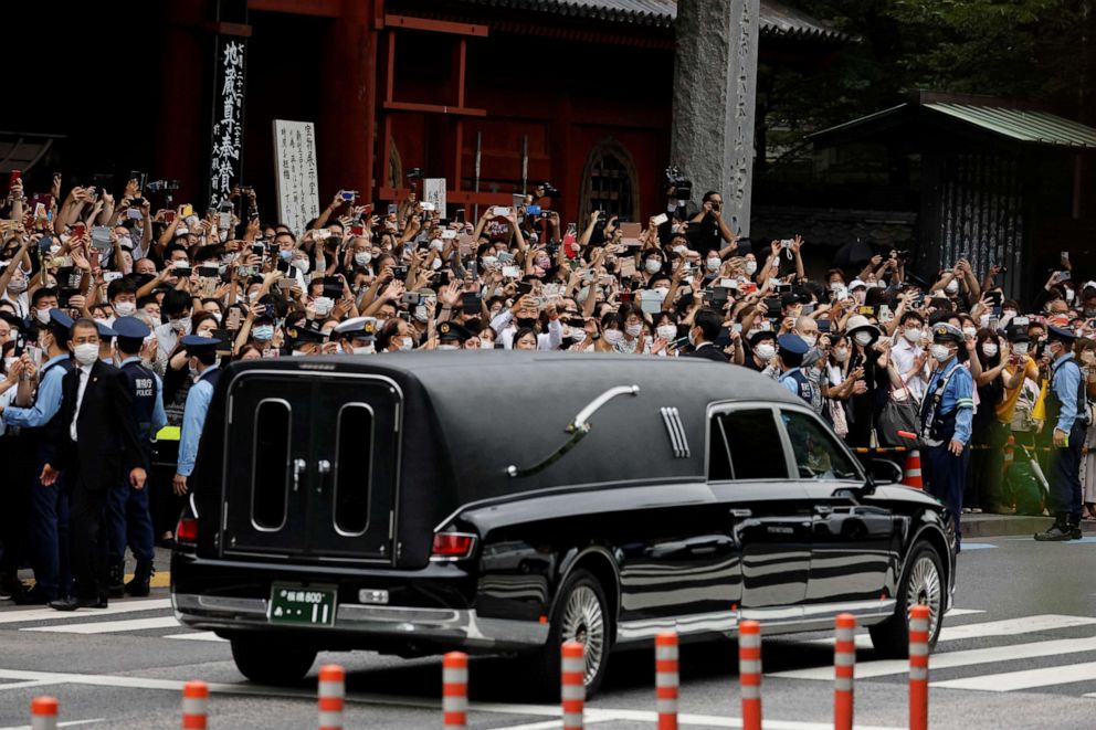PHOTO: A vehicle carrying the body of the late former Japanese Prime Minister Shinzo Abe, who was shot while campaigning for a parliamentary election, leaves after his funeral at Zojoji Temple in Tokyo, Japan, on July 12, 2022.