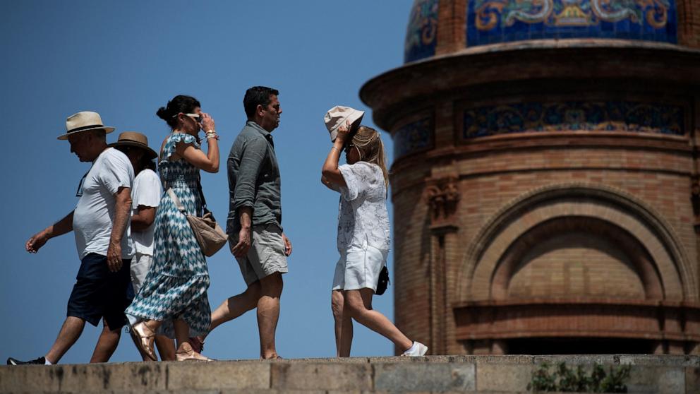 PHOTO: People protect themselves from the sun with hats in Seville, Spain, May 31, 2025.