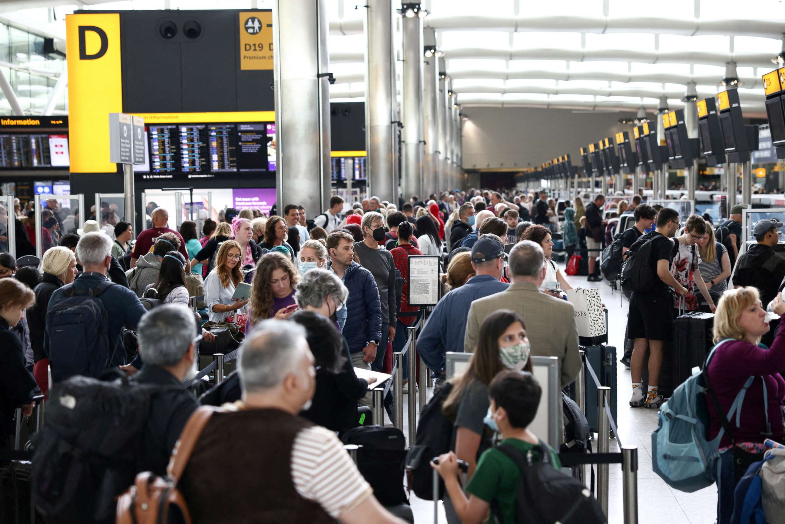 PHOTO: Passengers queue inside the departures terminal of Terminal 2 at Heathrow Airport in London, June 27, 2022.