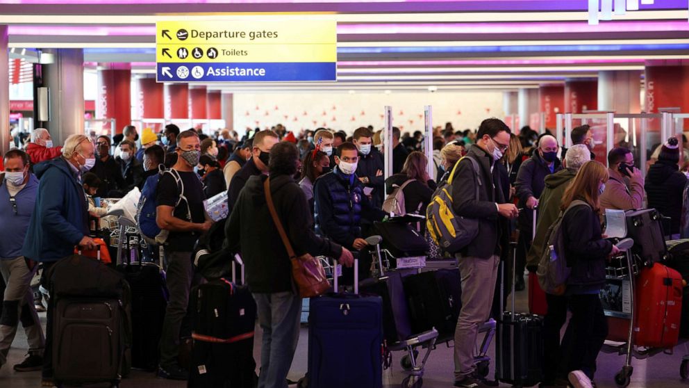 PHOTO: People queue to check into Virgin Atlantic and Delta Air Lines flights at Heathrow Airport Terminal 3, following the lifting of restrictions on the entry of non-U.S. citizens to the U.S., in London, Nov. 8, 2021.