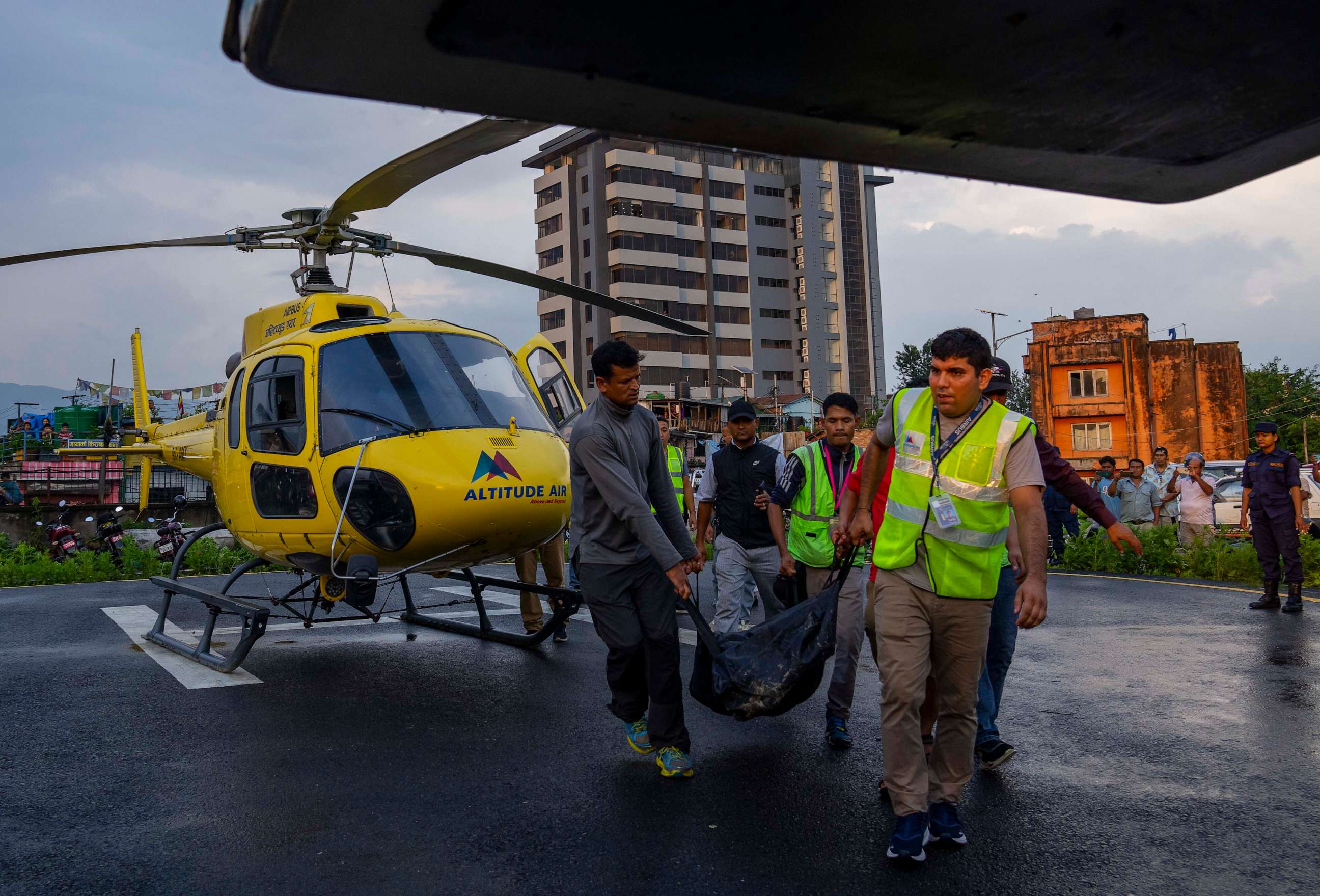 PHOTO: The body of a victim of a helicopter crash is carried out of a chopper in Kathmandu, Nepal, Tuesday, July 11, 2023